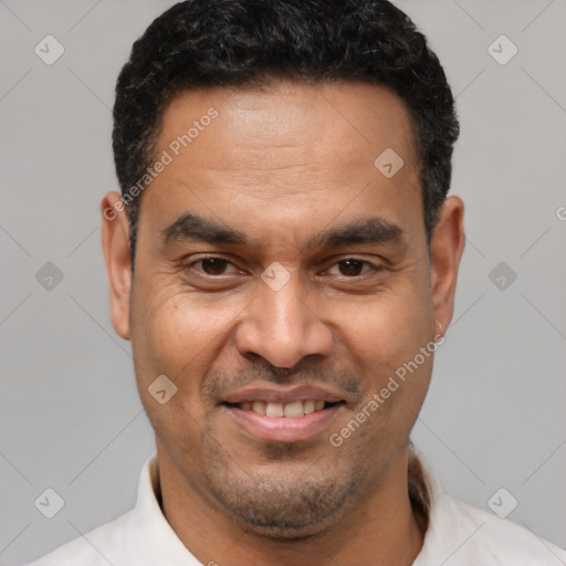 Joyful latino adult male with short  brown hair and brown eyes