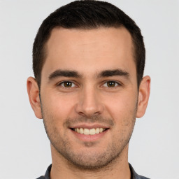 Joyful white young-adult male with short  brown hair and brown eyes