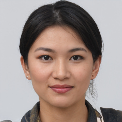 Joyful white young-adult female with medium  black hair and brown eyes
