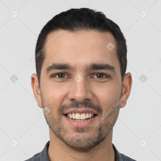 Joyful white young-adult male with short  black hair and brown eyes