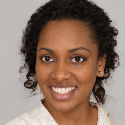 Joyful black young-adult female with medium  brown hair and brown eyes