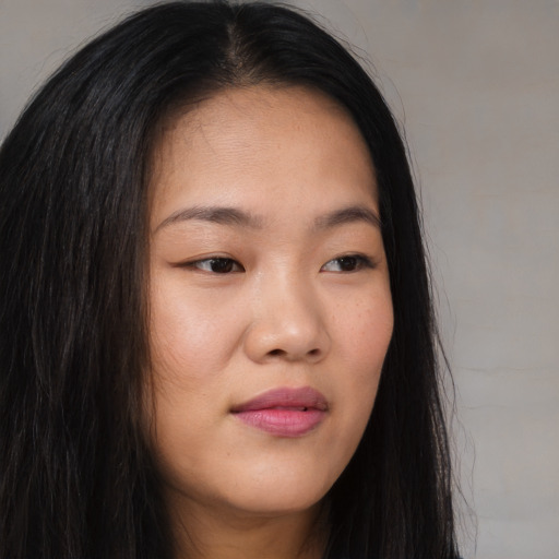 Joyful asian young-adult female with long  brown hair and brown eyes