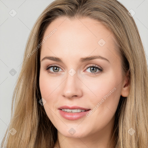 Joyful white young-adult female with long  brown hair and brown eyes