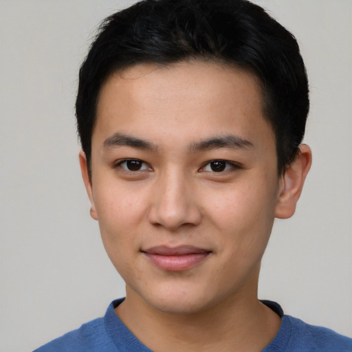 Joyful asian young-adult male with short  brown hair and brown eyes