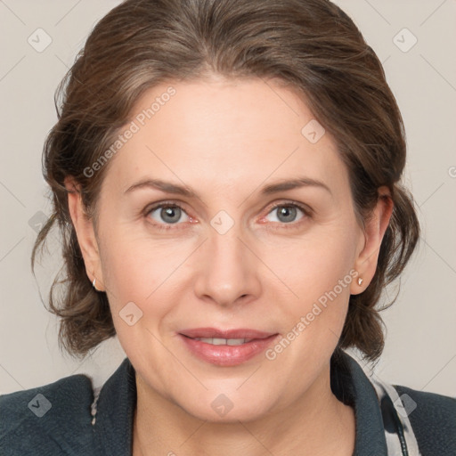 Joyful white adult female with medium  brown hair and grey eyes