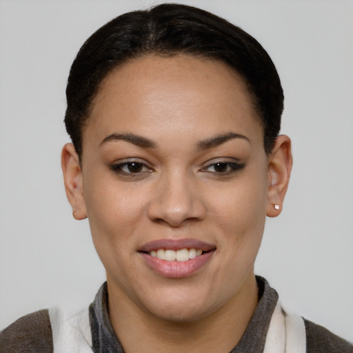 Joyful black young-adult female with short  brown hair and brown eyes