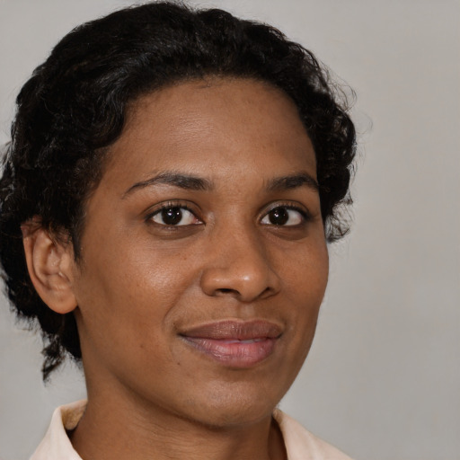 Joyful latino adult female with short  brown hair and brown eyes