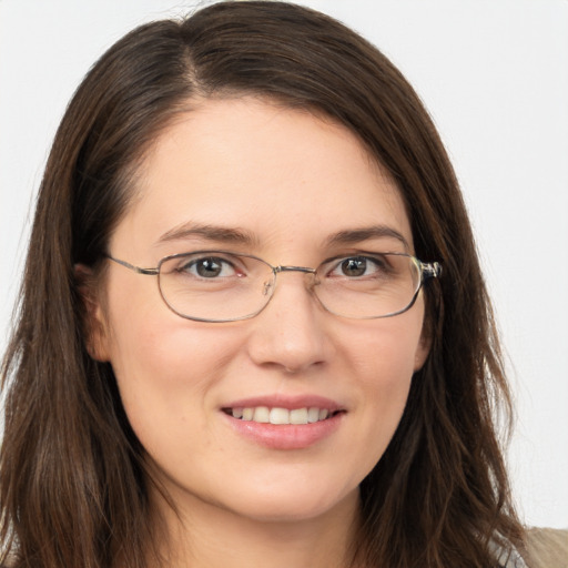 Joyful white young-adult female with long  brown hair and brown eyes