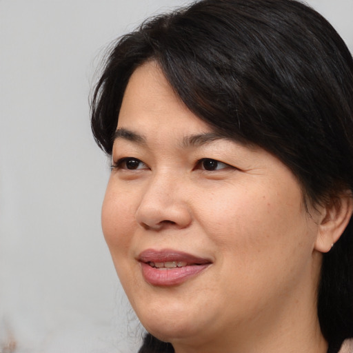 Joyful white adult female with medium  brown hair and brown eyes