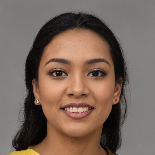 Joyful latino young-adult female with medium  black hair and brown eyes