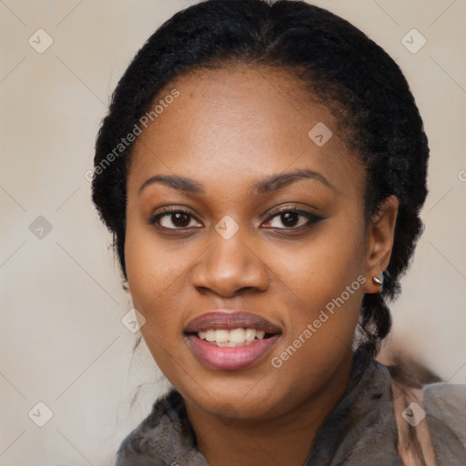 Joyful black young-adult female with long  black hair and brown eyes