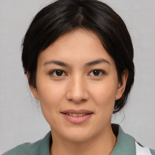 Joyful asian young-adult female with medium  brown hair and brown eyes