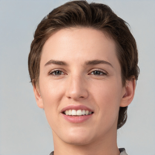 Joyful white young-adult female with short  brown hair and grey eyes