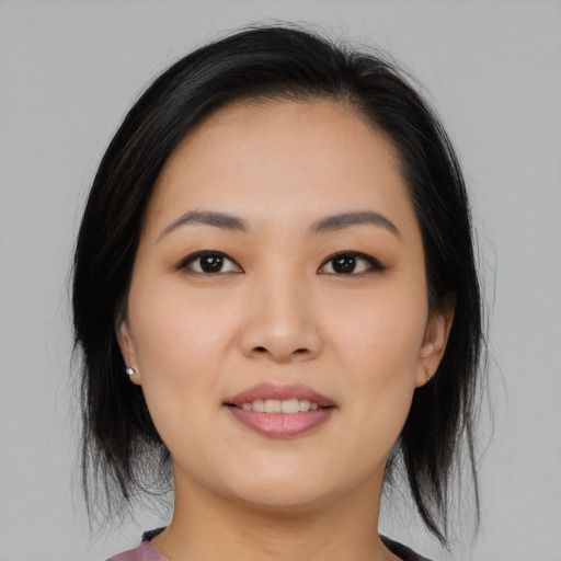Joyful asian young-adult female with medium  black hair and brown eyes