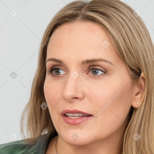 Joyful white young-adult female with long  brown hair and green eyes