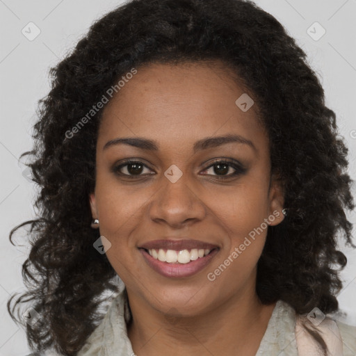 Joyful black young-adult female with long  brown hair and brown eyes