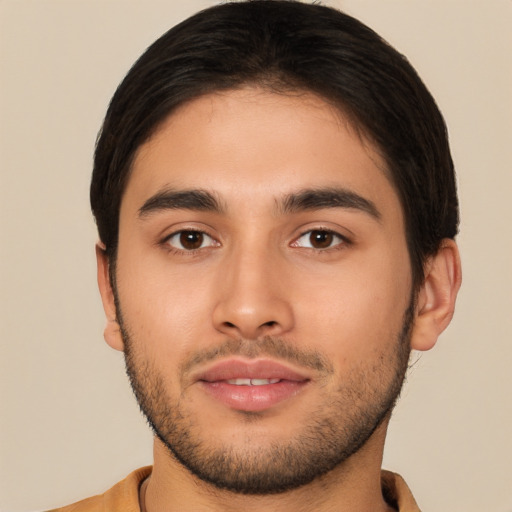 Joyful latino young-adult male with short  brown hair and brown eyes