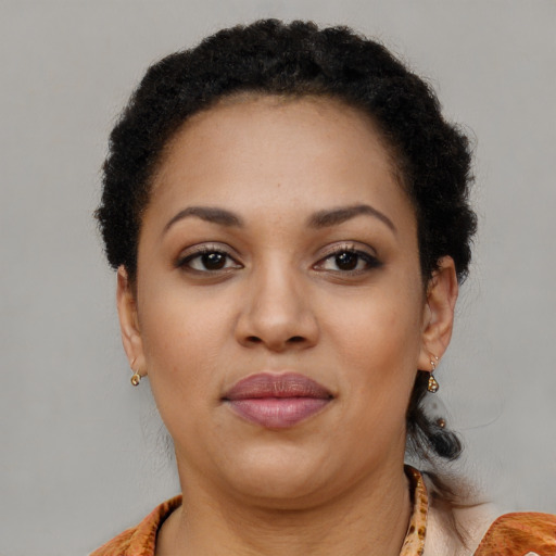 Joyful black young-adult female with short  brown hair and brown eyes