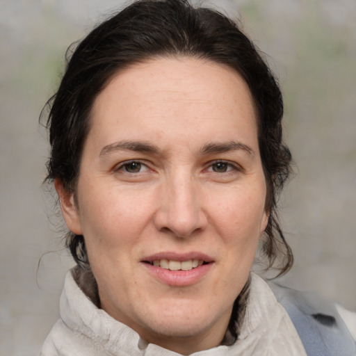 Joyful white adult female with medium  brown hair and brown eyes