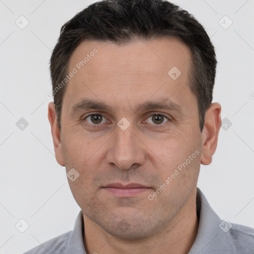 Joyful white adult male with short  brown hair and brown eyes