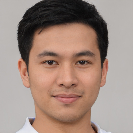 Joyful asian young-adult male with short  black hair and brown eyes