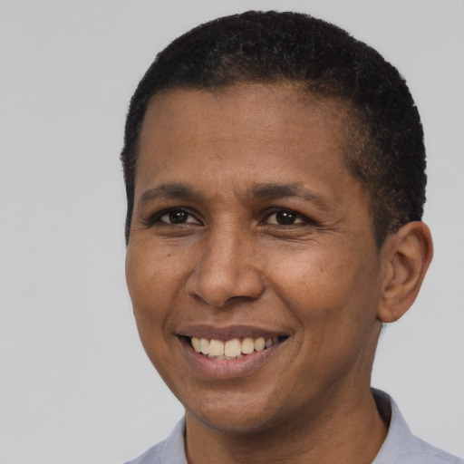 Joyful latino adult male with short  brown hair and brown eyes