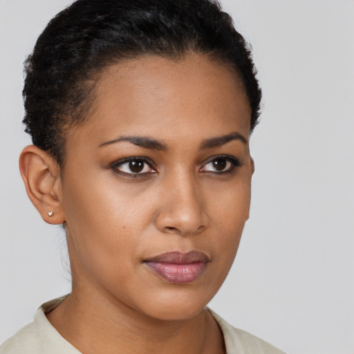 Joyful black young-adult female with short  brown hair and brown eyes