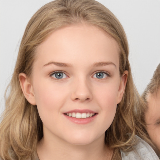 Joyful white child female with long  brown hair and grey eyes