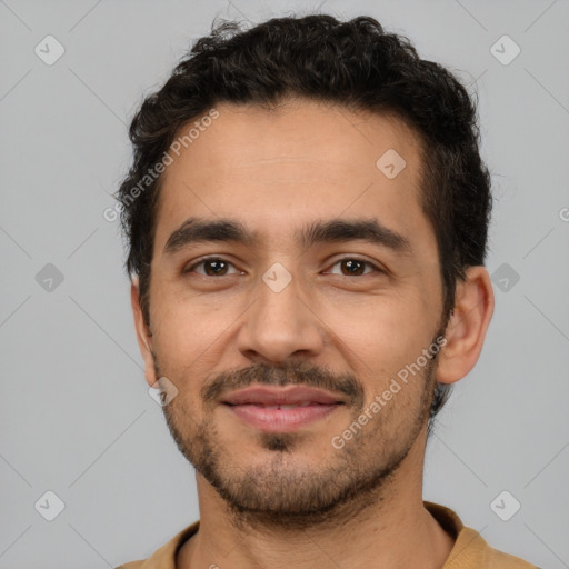 Joyful latino young-adult male with short  black hair and brown eyes