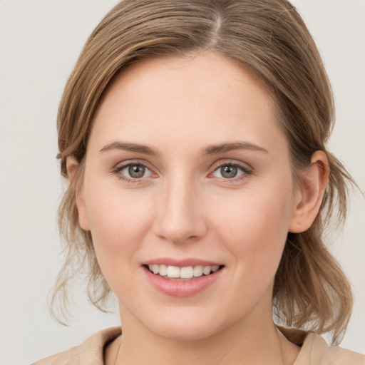 Joyful white young-adult female with medium  brown hair and blue eyes