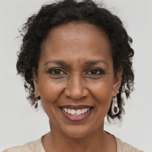 Joyful black adult female with short  brown hair and brown eyes