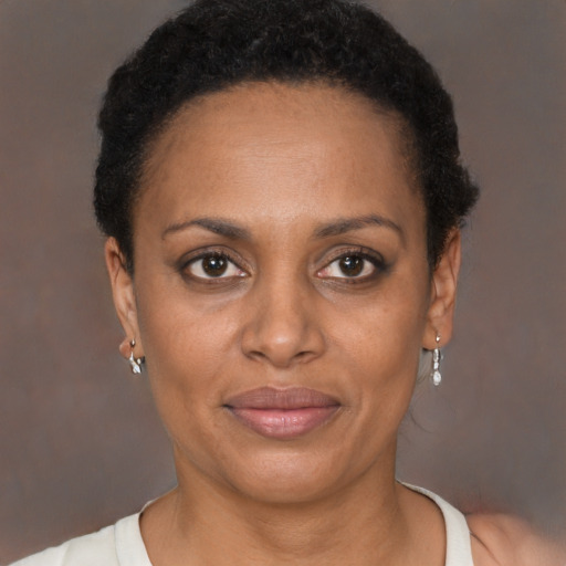 Joyful black adult female with short  brown hair and brown eyes