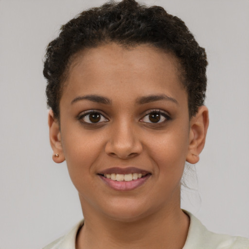 Joyful latino young-adult female with short  brown hair and brown eyes