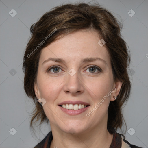 Joyful white adult female with medium  brown hair and grey eyes