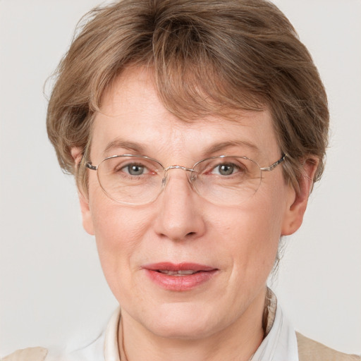 Joyful white middle-aged female with medium  brown hair and blue eyes