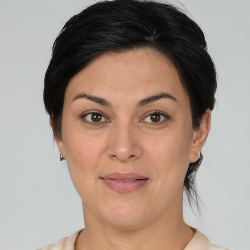 Joyful white adult female with medium  brown hair and brown eyes