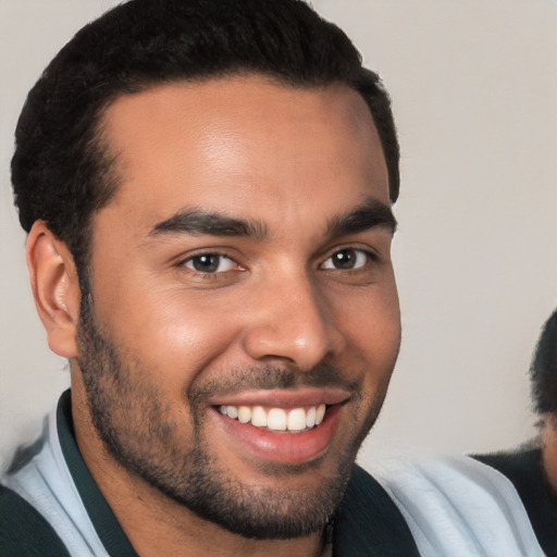 Joyful white young-adult male with short  black hair and brown eyes