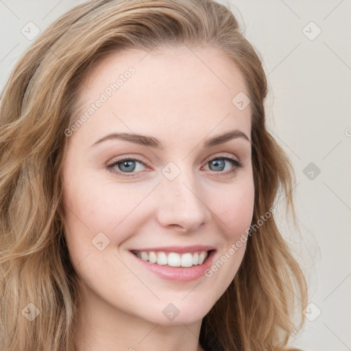 Joyful white young-adult female with long  brown hair and blue eyes