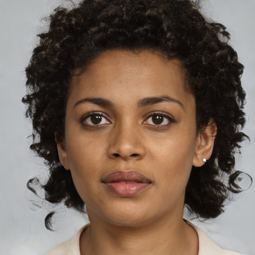 Neutral black young-adult female with medium  brown hair and brown eyes