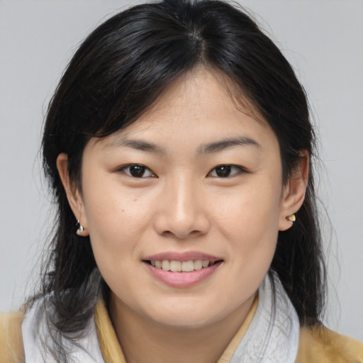 Joyful asian young-adult female with medium  brown hair and brown eyes