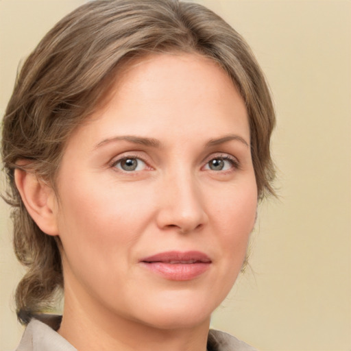 Joyful white adult female with medium  brown hair and grey eyes