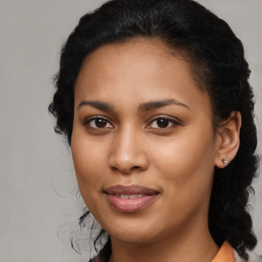 Joyful latino young-adult female with medium  black hair and brown eyes