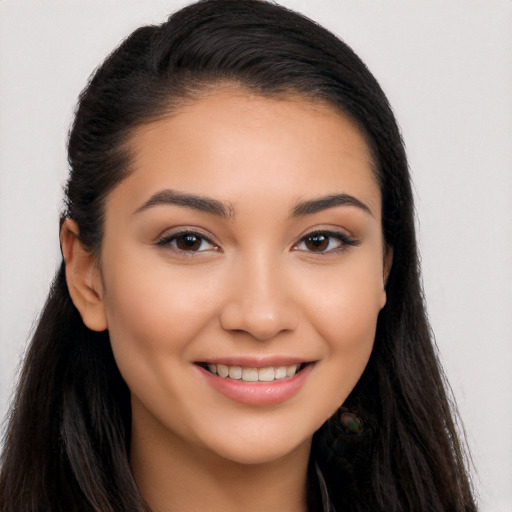 Joyful latino young-adult female with long  brown hair and brown eyes