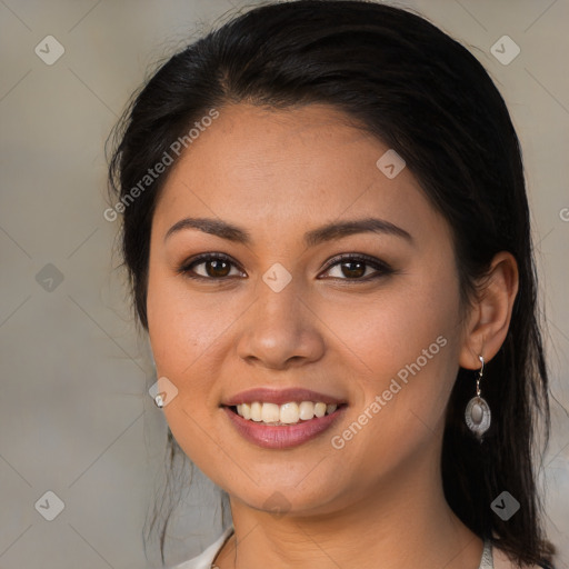 Joyful latino young-adult female with medium  brown hair and brown eyes