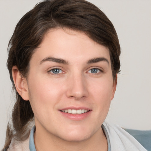 Joyful white young-adult female with medium  brown hair and grey eyes