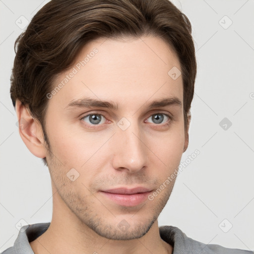 Joyful white young-adult male with short  brown hair and grey eyes