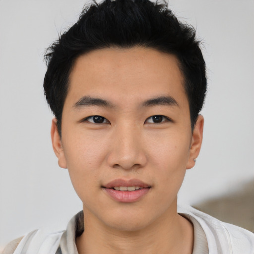 Joyful asian young-adult male with short  black hair and brown eyes