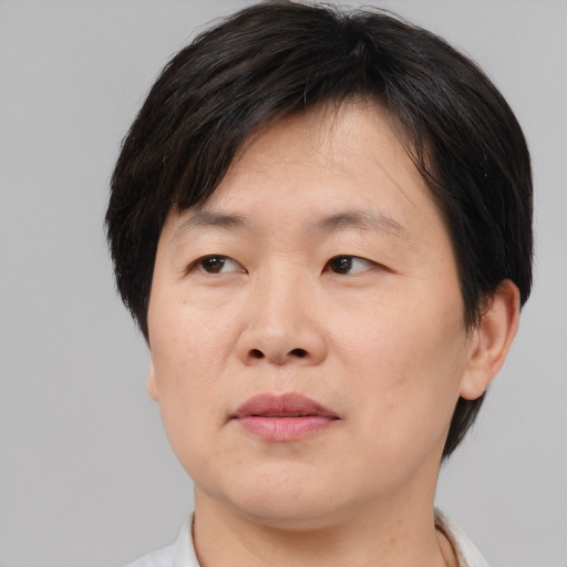 Joyful asian adult male with short  brown hair and brown eyes