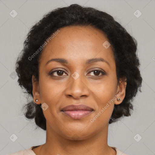 Joyful black adult female with medium  brown hair and brown eyes