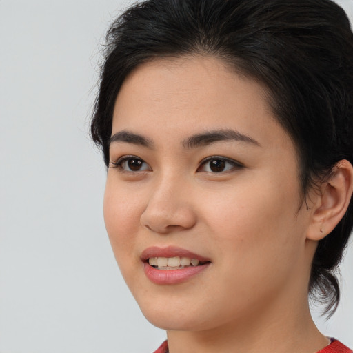 Joyful asian young-adult female with medium  brown hair and brown eyes